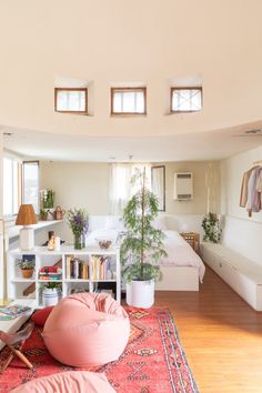 a living room filled with furniture and lots of windows on top of the ceiling,