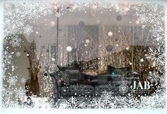 the window is decorated with snowflakes and christmas decorations, including a couch in front of it