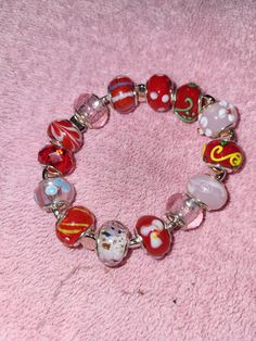 This is a mainly red colored glass beaded bracelet with multiple included colors. It is made using a stretching jewelry cord.  FREE SHIPPING!! Cheap Red Beaded Charm Bracelet, Red Bracelets With Heart Beads, Casual Red Charm Bracelet Gift, Red Beaded Charm Bracelet For Jewelry Making, Red Faceted Bead Bracelets As Gift, Red Beaded Bracelets With Faceted Beads For Gift, Red Faceted Beads Bracelet As A Gift, Red Faceted Beaded Bracelet As A Gift, Adjustable Red Charm Bracelet For Party