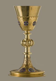 an ornately decorated goblet with blue and gold decorations