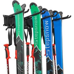 the skis are lined up against the wall for storage and hanging on the rack