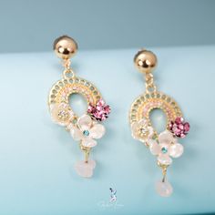 These gorgeous bohemian flower dangle drop earrings feature beautiful crystal and resin flower on bohemian design dangle drop with colored crystal gemstones, this pair of flower drop earrings will elevate your outfit and make you shine at the party. Add these beautiful bohemian flower drop earrings to your everyday party fashion earrings collection or as gift for your love one. Materials: alloy, rhinestone, resinFinish: gold color Jewelry Care: See more information about how to care for your jew Bohemian Jeweled Crystal Dangle Earrings, Elegant Floral Print Earrings For Spring, Elegant Spring Flower Earrings With Floral Print, Elegant Floral Print Flower Earrings For Spring, Bohemian Crystal Drop Earrings, Elegant Floral Print Earrings, Bohemian Crystal Chandelier Drop Earrings, Floral Print Flower Jewelry For Parties, Bohemian Drop Earrings With Floral Print