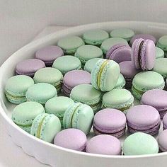 a white container filled with lots of different colored macaroons