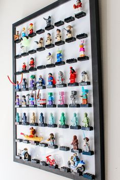 legos are arranged on the wall to display their individual figures in this unique display