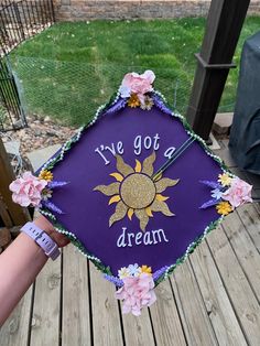 a purple graduation cap that says i've got a dream with flowers on it