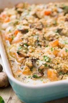 a casserole dish with carrots and mushrooms in it