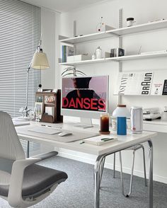 a white desk with a computer on top of it