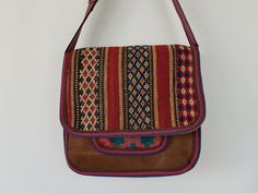 This is a medium sized bag with a flap on front accented with a cute bow. Also available without bow. It has a long strap and can be worn cross body or as shoulder bag. There is an open top small pocket under the flap. This bag is available 4 pieces and each has a different tapestry for the small pocket under the flap. Please choose from drop down menu which one you want. The bow tapestry color may change a bit but still matching to the bag body tapestry. This bag is large enough to hold your da Brown Tapestry Bag With Top Carry Handle, Brown Tapestry Shoulder Bag With Handles, Brown Tapestry Bags With Adjustable Strap, Bohemian Hand-stitched Crossbody Satchel, Leather Interior Design, Vintage Tapestry Bag With Adjustable Strap, Medium Sized Bags, Faux Leather Bag, Hippie Bags