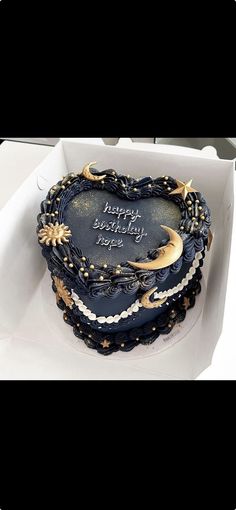 a heart shaped cake in a box with writing on the side and stars around it