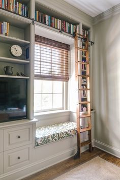 there is a ladder leaning up against the bookshelf