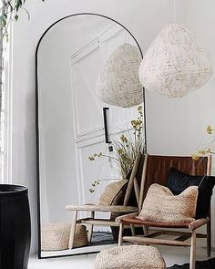 a living room filled with furniture and a large mirror