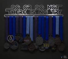 medals are hanging on a wall with the words do or don't there is no try