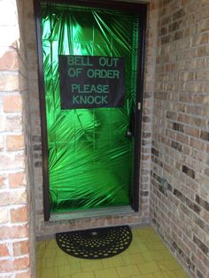 a green door with a sign that says bell out of order please knock