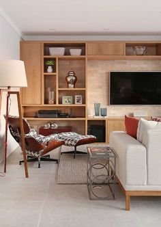 a living room filled with furniture and a flat screen tv