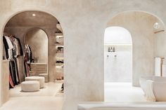 a bathroom with an arched doorway leading to another room that has a bathtub in it