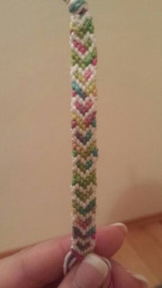 someone is holding a colorful bracelet in their hand and it looks like they have been made out of beads