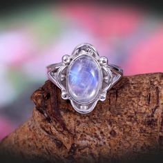 "This Sterling Silver Ring features an Elegant Art With Natural Rainbow Moonstone Gemstone. The cavity is made from genuine solid 925 sterling silver and stamped as S925. This Jewelry is Lead free. ITEM DESCRIPTION Item Code: JARG14 Metal: 925/92.5 Sterling Silver Gemstone: Genuine Natural Rainbow Moonstone Cabochon (Handmade) Gemstone Shape: Oval Gemstone Quality: AAA+ Gemstone Size: 8X12 MM Ring Length: 17 MM Ring width: 14 MM Weight: 5.46 gm **Keep the jewelry away from direct heat, water, pe Bohemian Silver Moonstone Ring, Bohemian Moonstone Cabochon Jewelry, Bohemian Oval Cabochon Moonstone Ring, Bohemian Moonstone Cabochon Ring, Silver Bohemian Moonstone Cabochon Ring, Silver Bohemian Moonstone Ring, Bohemian Silver Opal Open Ring, Silver Cabochon Moonstone Ring In Bohemian Style, Bohemian Silver Open Opal Ring