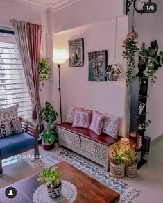 a living room filled with furniture and lots of plants