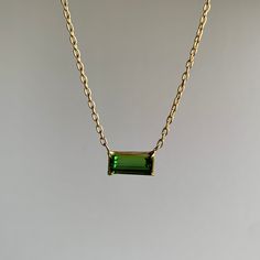 This glowing verdant tourmaline is elegantly poised on a delicate gold chain, perfect for layering and everyday wear. 18k gold handmade clasp, 14k chain Green tourmaline 10mm x 5mm (3/8" x 3/16")Necklace is 18" long Gem Necklace, Design Movements, Green Tourmaline, Emerald Cut, Gold Chains, Tourmaline, Emerald, Everyday Wear, 18k Gold