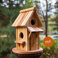 a wooden bird house sitting on top of a tree stump