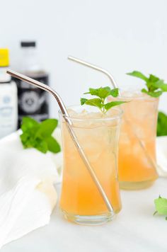 two glasses filled with lemonade and garnished with mint