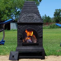 an outdoor fireplace in the middle of a field