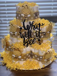 a three tiered cake decorated with bees and the words, what will it bee?