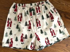 "ATTENTIONWE ARE AT FULL CAPACITY FOR  DELIVERY BY CHRISTMAS FOR 2023 . You can still place an order, however..we can not guarantee that it will ship, or that you will  receive it by Christmas Day!One pair of  Olde Time Christmas Santa Flannel Pajama shorts! You can finding matching pants here:   -100% flannel - Handmade in the USA by me in Virginia -  1/2\"  elastic waist with/wo decorative bow (the elastic is not adjustable like the matching pants) - contrast fabric edging on the hem    How do you find your size?????   measure your hips and then look at the size chart, the hips are the most important measurement. If you need a smaller or bigger waist, just send a note with the order.  Women's                                            Waist:  XS (25-27)  S(28-29)     M(29-30    L(31-32) Christmas Pajama Shorts, Shorts Pjs, Christmas Pj Pants, Rebecca Brown, Christmas Pj, Womens Pajama Shorts, Christmas Pjs, Flannel Pajamas, Pj Pants