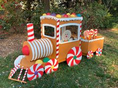 a toy train with candy canes and a teddy bear in the driver's seat