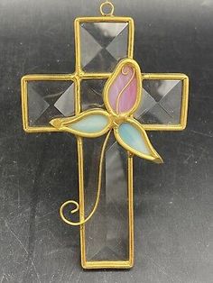 a cross with a pink flower on it