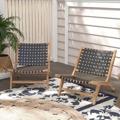 two wooden chairs sitting on top of a rug