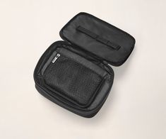 an empty black case with zippers on the inside is shown in front and back