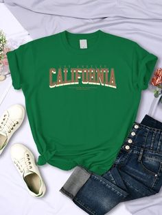 These Los Angeles California Printed Cool T-Shirts are the perfect addition to your wardrobe. Made with high-quality materials, they feature a unique design that showcases the beauty and vibrancy of the city. Show off your love for LA while staying cool and stylish. Available in a range of sizes for the perfect fit. Designed by 4COLORDRESS Green Graphic Print Top For College, Urban Green Top With Letter Print, Summer College Slogan T-shirt, Summer College T-shirt With Text Print, Green Urban Top With Text Print, Urban Green Tops With Text Print, Urban Green Tops For College, Green College T-shirt With Text Print, College Green T-shirt With Text Print