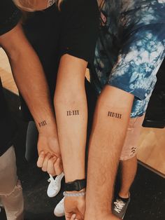 two people with matching tattoos on their arms