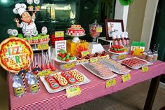 a table topped with lots of food and desserts