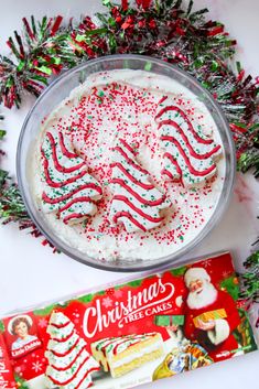 a christmas cake with white frosting and candy canes on the side next to it