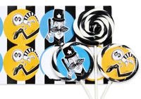 the lollipops are decorated with black, white and yellow striped paper decorations