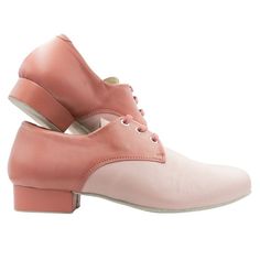 a pair of pink shoes with laces on the top and heeled soles