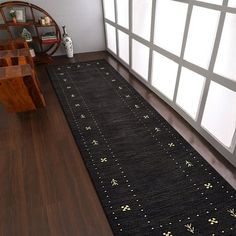 a black area rug with gold stars on it in front of a large glass window