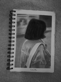 a black and white photo of a woman's back with the words love is in the air written on it