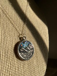 This is a silver pendant with a wave on top of abalone hanging on a sterling silver chain. Sterling Silver Wavy Necklace For Gifts, Silver Wavy Necklace For Gift, Handmade Silver Wavy Jewelry, Wave Necklace, Sterling Silver Chain, Sterling Silver Chains, Pendant Necklaces, Silver Pendant, Silver Chain