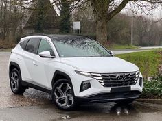 a white suv is parked in the parking lot