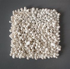 there are many small white objects on the table, and one is made out of clay