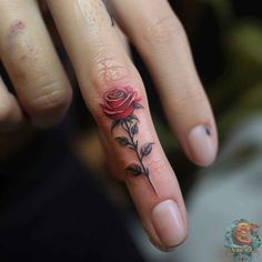 a woman's hand with a rose tattoo on it