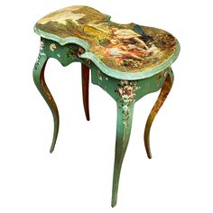 an ornate painted table with two legs and a painting on it's side shelf