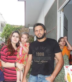 a man standing next to two women and a child