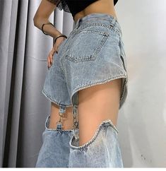 a woman wearing high waist jeans with holes on the side