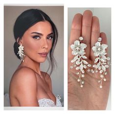 the woman is wearing two earrings on her finger and one has an open ring with flowers