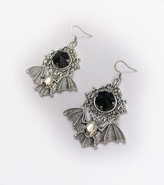 These large gothic vampire inspired earrings are made with antiqued silver plated bats, filigree settings and stainless steel earring hooks,  accented with sparkling glass crystals in JET BLACK. Earrings measure 2 3/4" tall and are 1 7/8" wide.Matching necklace is available in our shop. If you would like these in a different stone color, please send us a message. Vampire Style Metal Earrings For Halloween, Halloween Vampire Metal Earrings, Gothic Silver Metal Earrings, Vampire Style Metal Pierced Earrings, Silver Gothic Metal Earrings, Silver Witchy Earrings For Party, Silver Punk Earrings For Halloween, Silver Witchy Party Earrings, Gothic Metal Earrings For Party