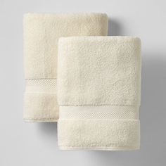 two white towels hanging on the wall